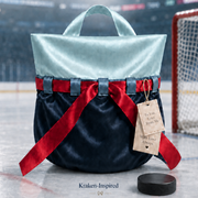 A luxury gift bag with a light blue top and dark navy bottom, tied with a red ribbon, through steel grey blue ribbon loops.  Change the ribbon out to white, cream or other options!