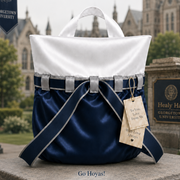 A navy velvet and white satin topped luxury gift bag with blue and grey ribbon in light grey ribbon loops.  Go Hoyas!
